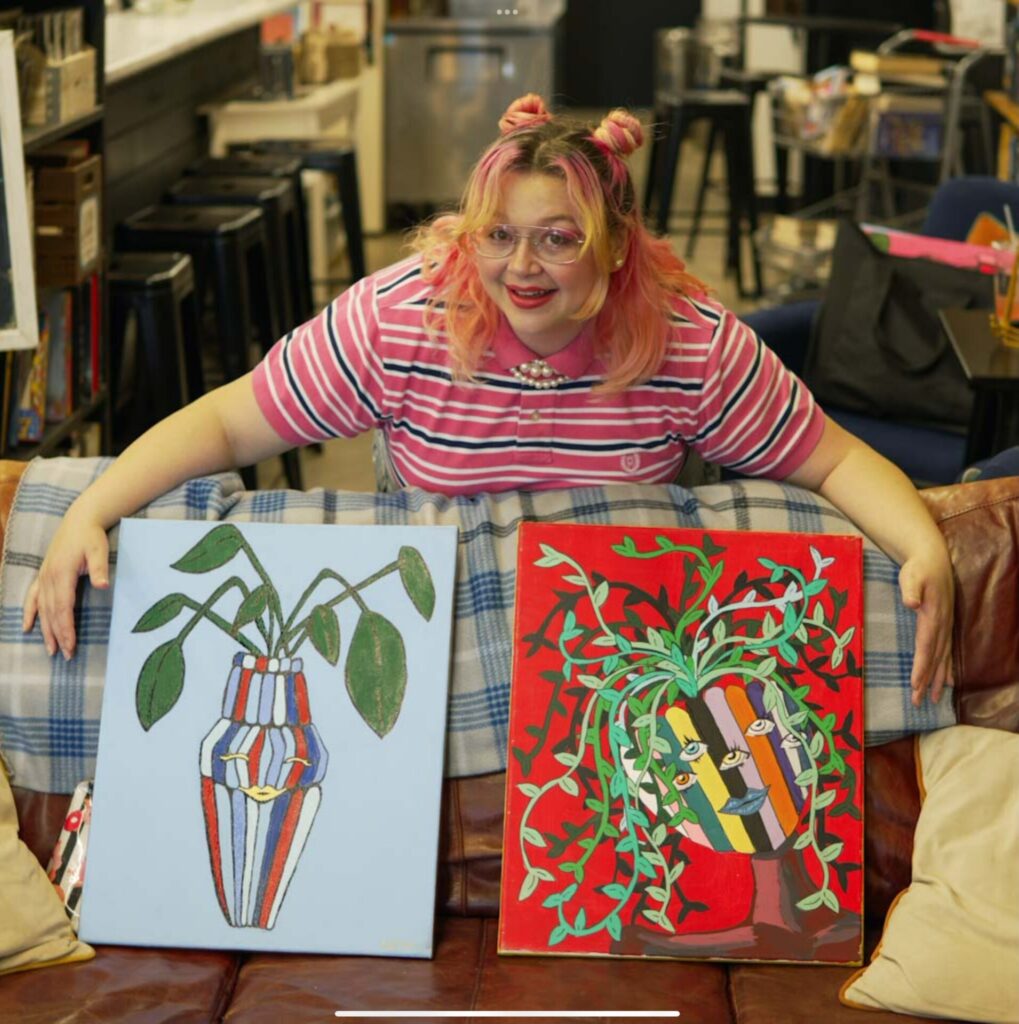 Rachel Lawson with her paintings at Blue's Brew.